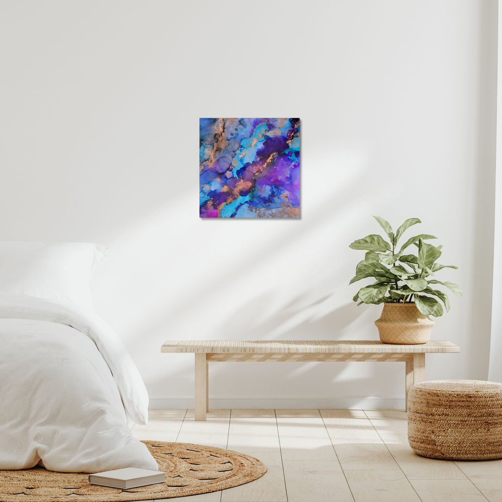 Abstract canvas print featuring alcohol ink design by Yurmaze in blue, purple, and gold tones, displayed as modern wall art in a minimal interior.