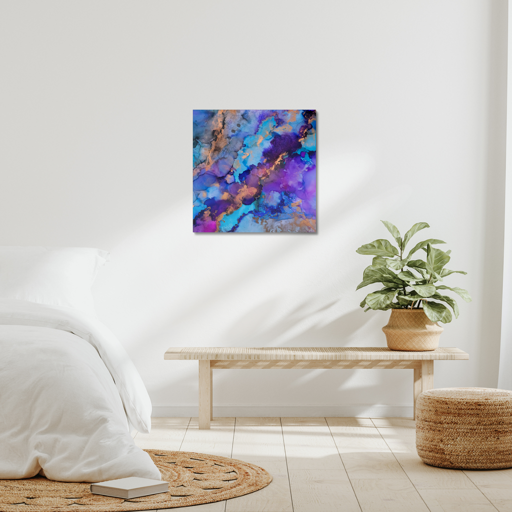 Abstract canvas print featuring alcohol ink design by Yurmaze in blue, purple, and gold tones, displayed as modern wall art in a minimal interior.